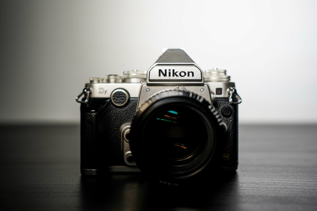 Elegance Through the Lens: Captivating Black and Silver Nikon DSLR Camera in Majestic 8K Wallpaper