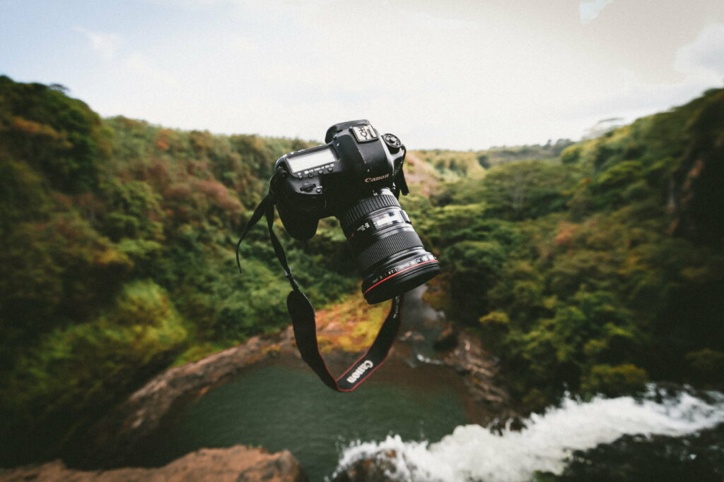 Capturing Precious Moments: A Sleek Black Canon DSLR amidst a Stunning 5K Wallpaper Backdrop