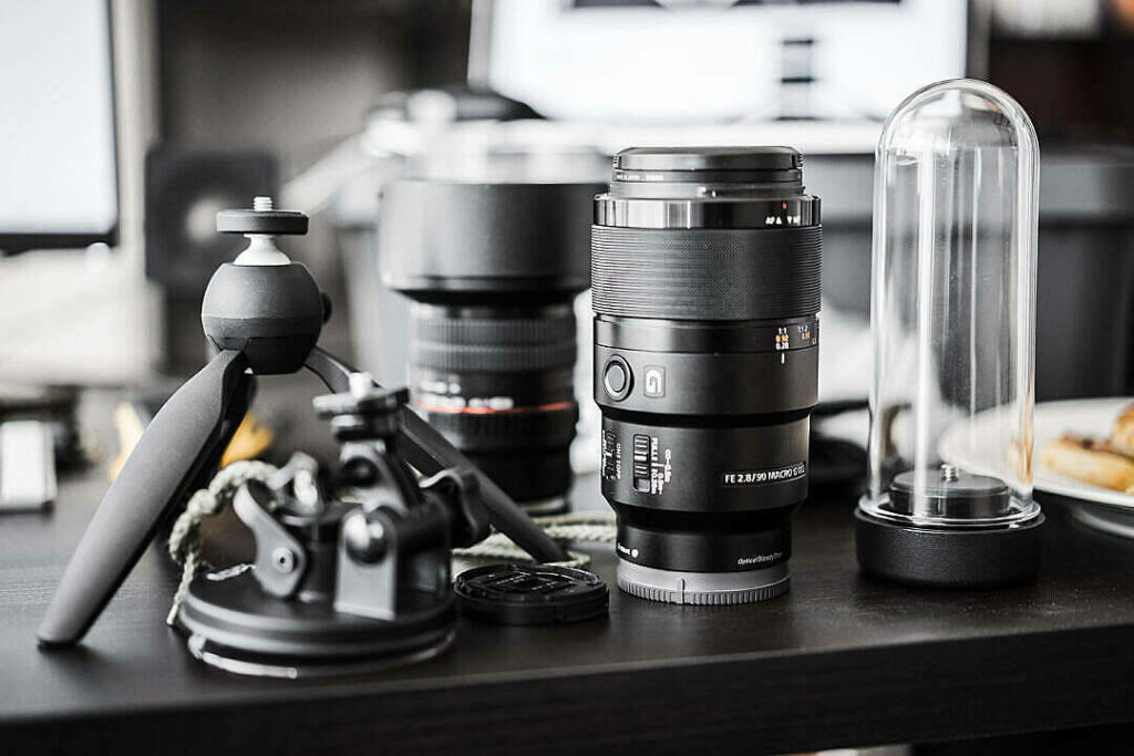 Capturing the Beauty: A Display of Camera Lenses and Photography Gear on a Stylish Work Desk Wallpaper