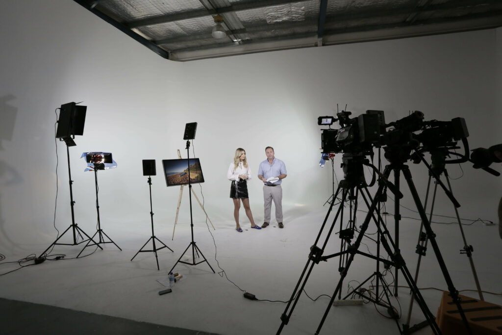 Creative Collaboration: Immersed in a Dynamic Video Shoot at the Vibrant Photography Studio Wallpaper