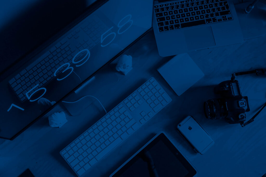 Mysterious and Modern: Capturing a Dark Computer Desk with an Iphone in the Background Wallpaper
