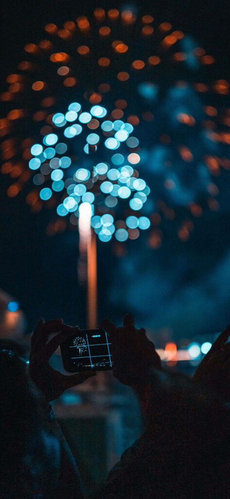 Capturing the Spectacular: Blue and Red Fireworks in iPhone 2021 Background Picture Wallpaper