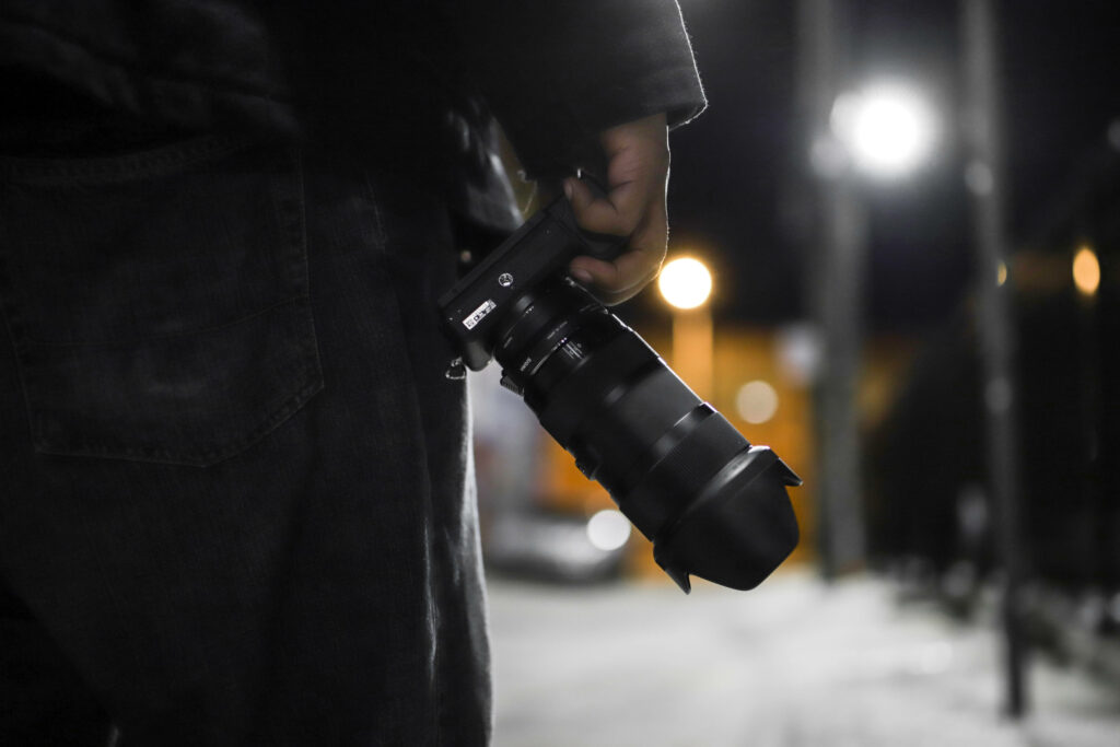 Capturing the Night: A Striking Sony DSLR Camera Illuminates the Dark Outdoors Wallpaper