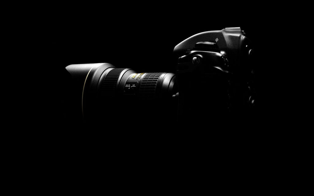 Mesmerizing DSLR Camera: Captivating Side-Lit Render on Enigmatic Dark Background Wallpaper