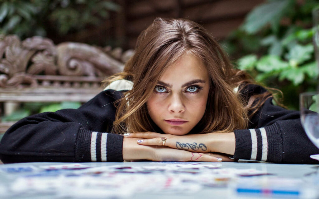 Stunning Cara Delevingne Tattoo Wallpaper with Intense Focus
