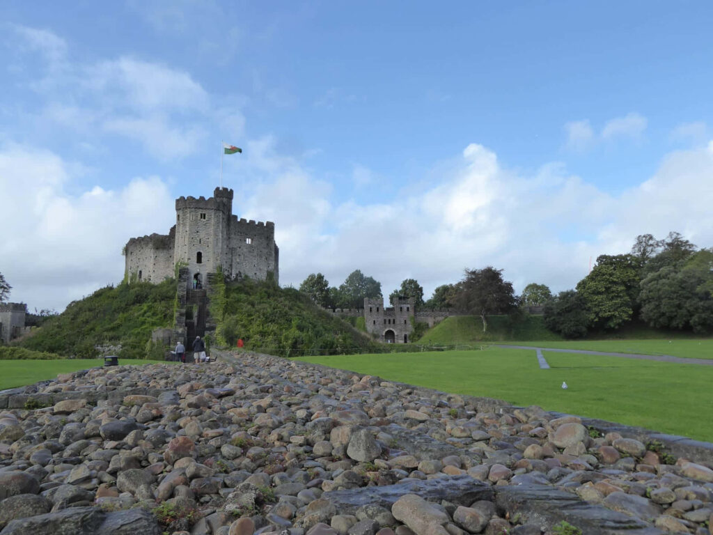 Cardiff Castle with weathered rocks lush green lawns and dramatic sky historic architecture wallpaper
