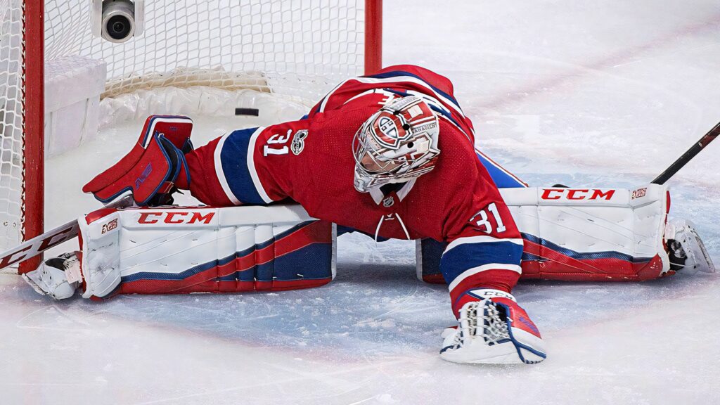 Carey Price NHL goalie in Montreal Canadiens gear making a save intense professional hockey wallpaper