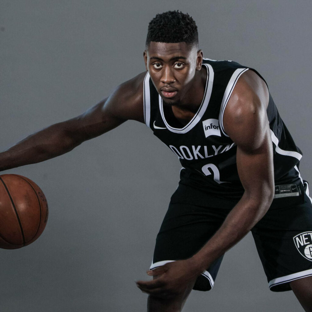 Caris LeVert in Brooklyn Nets uniform basketball portrait action pose gray studio background Wallpaper