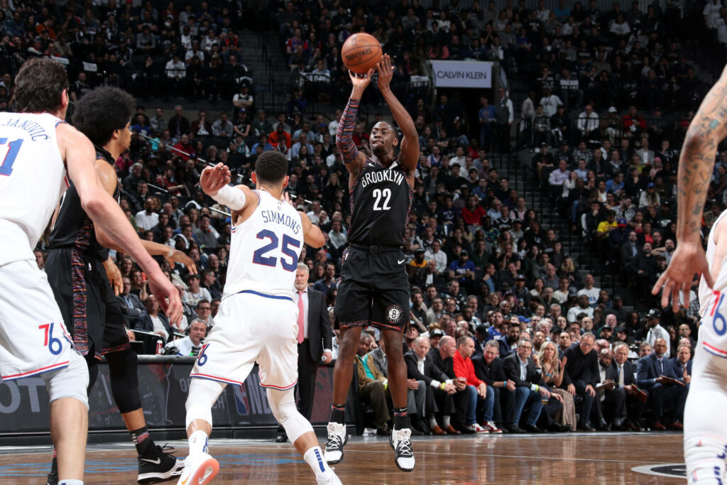 Caris LeVert Brooklyn Nets mid-air jump shot intense crowd dynamic basketball game wallpaper