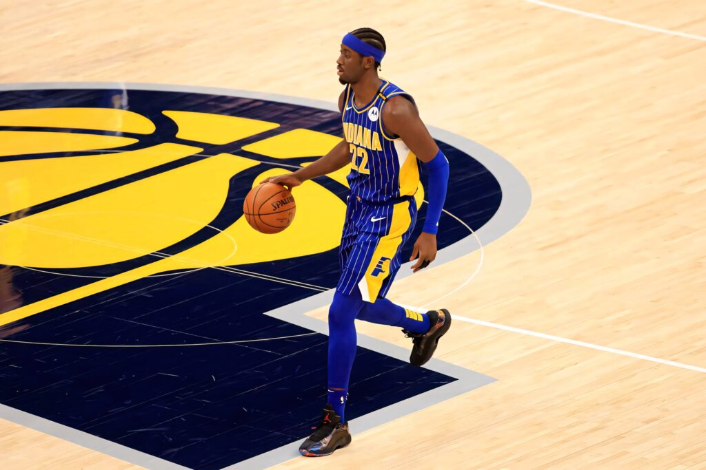 Caris LeVert Indiana Pacers number 22 dribbling basketball in blue yellow pinstripe uniform Wallpaper