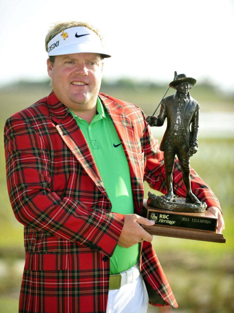 Carl Pettersson in red plaid jacket holding RBC Heritage Champion trophy in bright daylight Wallpaper