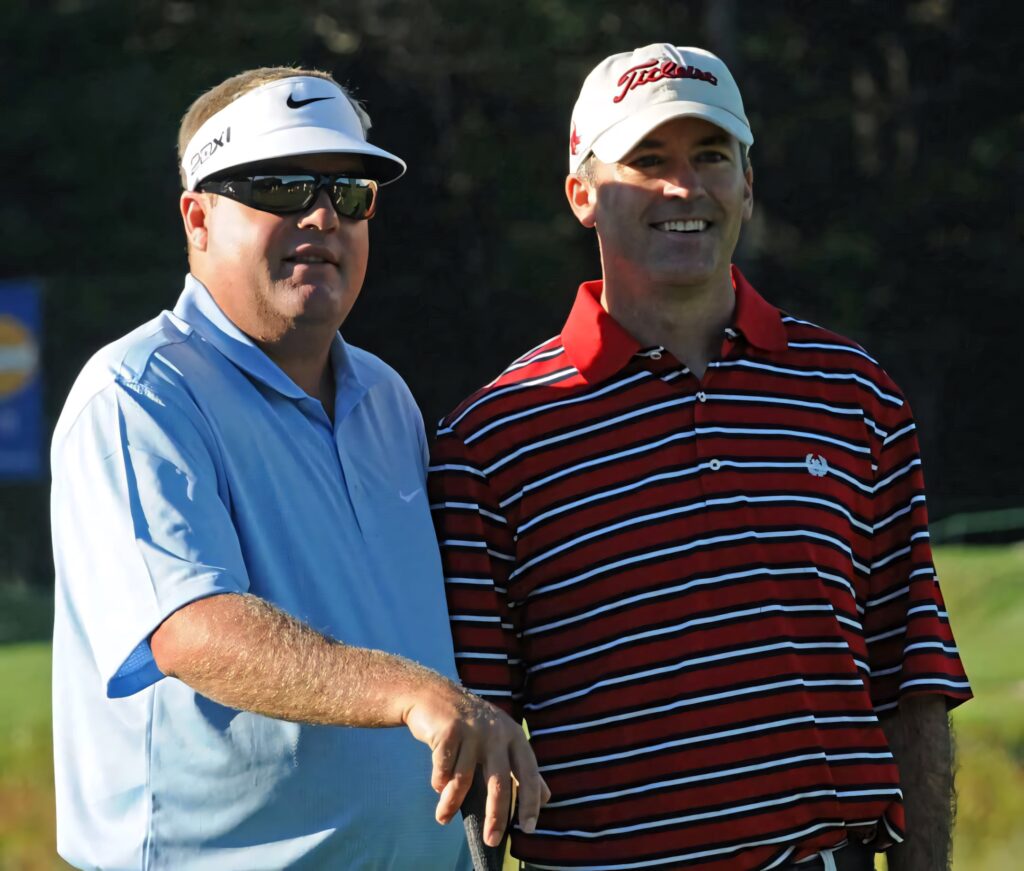 Swedish golfer Carl Pettersson with pro-am partner on sunny golf course in sporty apparel Wallpaper