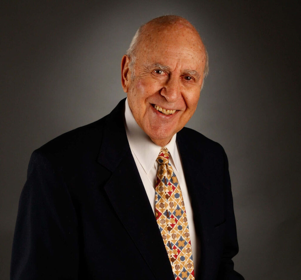 Carl Reiner portrait wallpaper in dark suit white shirt patterned tie warm smile gray background