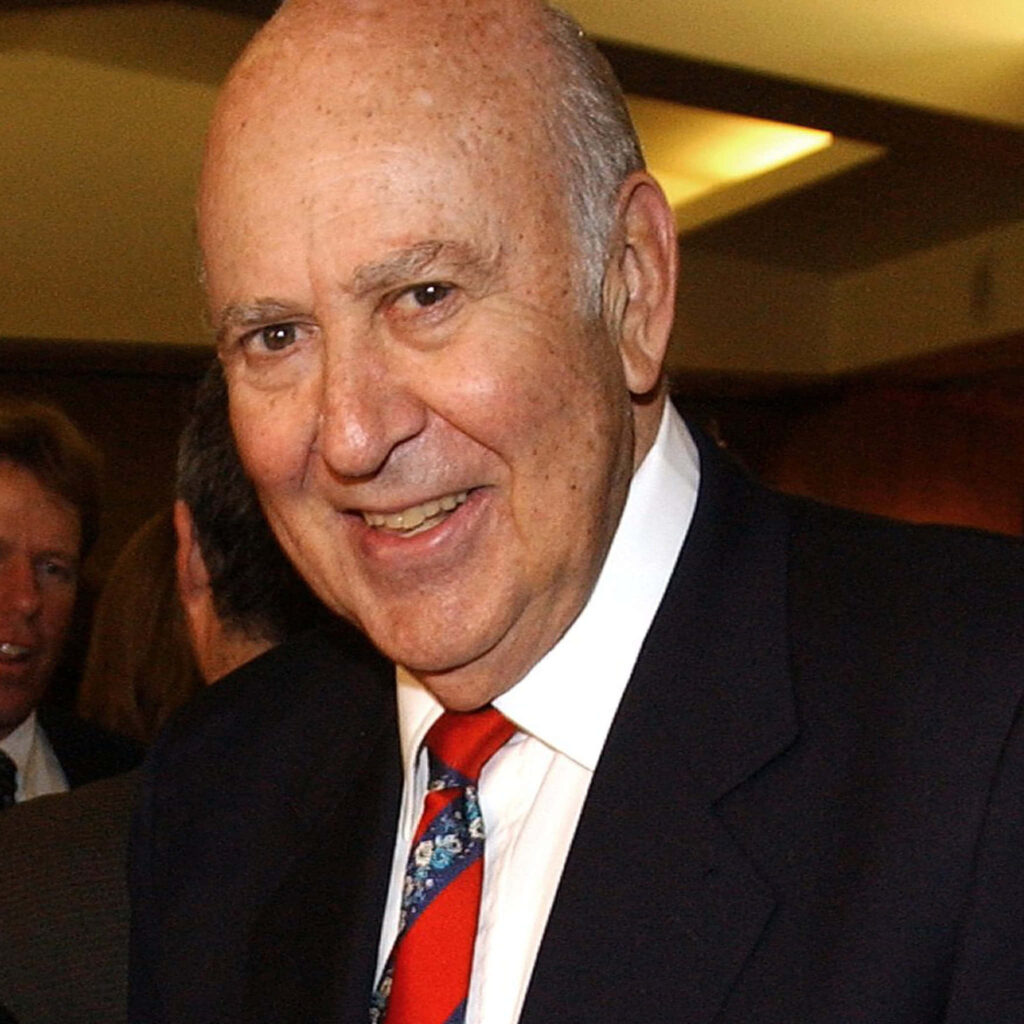 Carl Reiner candid portrait in classic suit and colorful tie with soft blurred background wallpaper