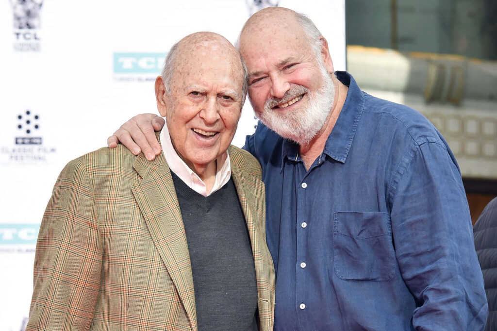 Carl Reiner and son Rob Reiner smiling outdoors vibrant family bond filmmaker wallpaper background