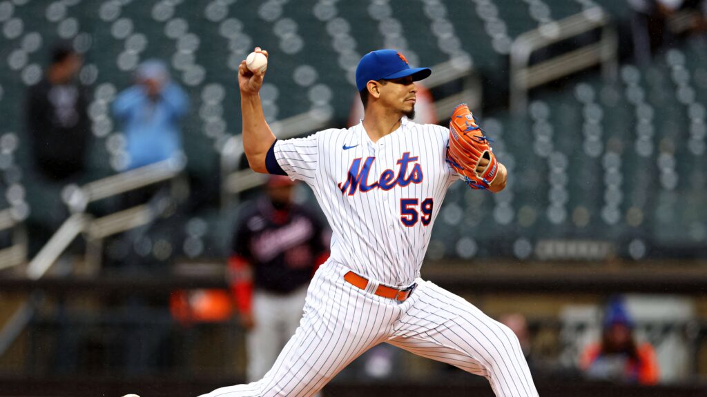 Carlos Carrasco pitching in New York Mets uniform with dynamic motion and intense focus Wallpaper