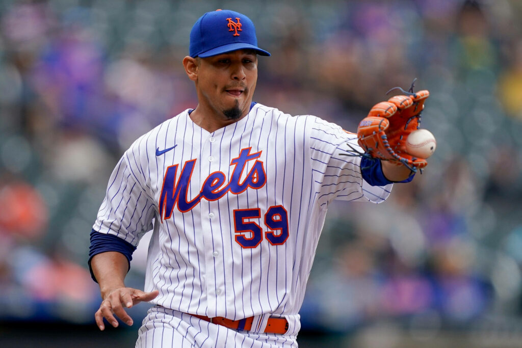Carlos Carrasco catching baseball in New York Mets uniform showing focus in game action Wallpaper