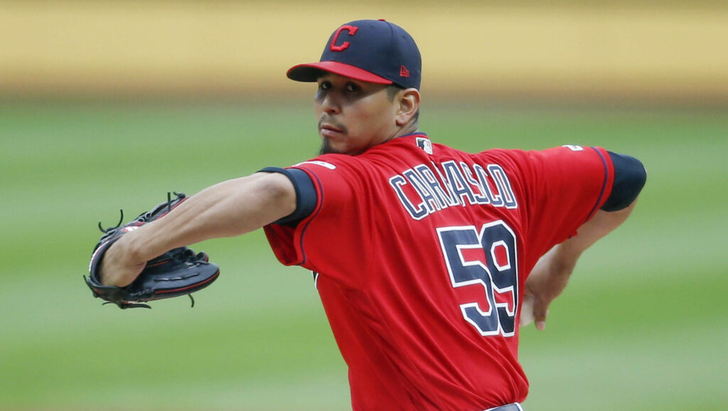 Carlos Carrasco pitching in red Cleveland Indians uniform number 59 intense focus stadium background Wallpaper