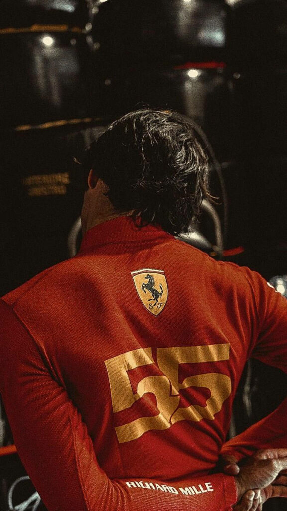 Carlos Sainz Jr in red Ferrari racing suit number 55 dynamic Formula 1 motorsport wallpaper background