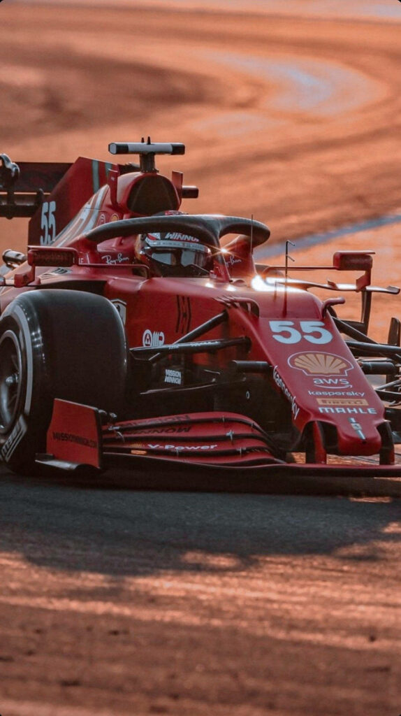 Carlos Sainz Jr racing red Formula 1 car Saudi Arabian circuit intense focus sunset wallpaper