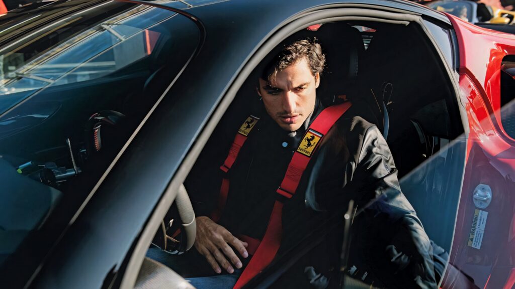 Carlos Sainz Jr in red Ferrari focused inside race car high performance racing wallpaper background