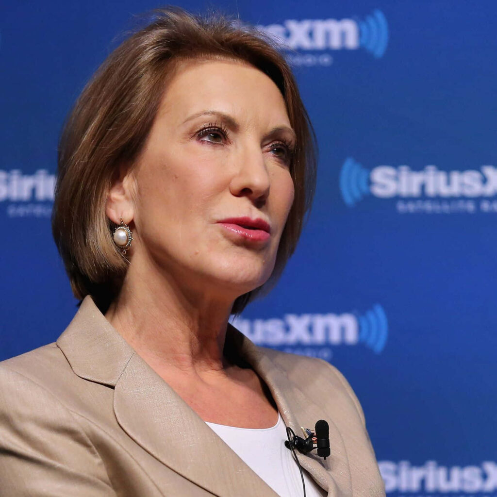 Carly Fiorina in beige blazer speaking during SiriusXM radio interview with lapel microphone Wallpaper