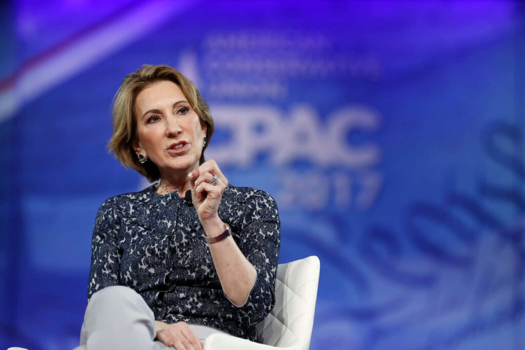 Carly Fiorina speaking at 2017 CPAC conference in formal top with blue CPAC logo backdrop Wallpaper