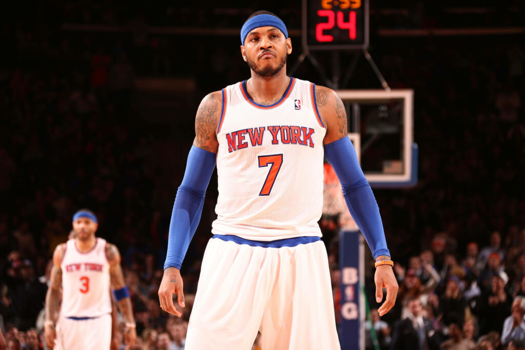 Carmelo Anthony in New York Knicks number 7 jersey with intense game face under arena lights Wallpaper