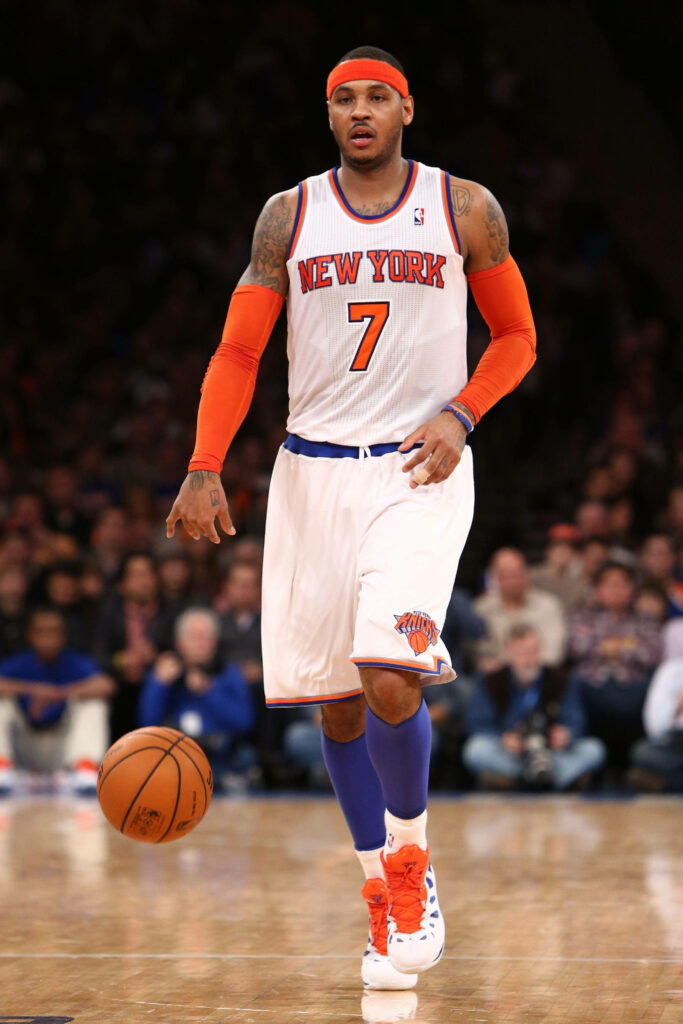Carmelo Anthony dribbling in New York Knicks uniform vibrant orange blue NBA action wallpaper