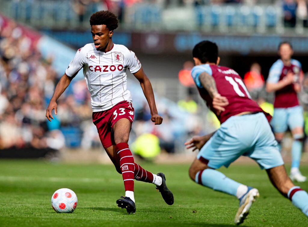 Carney Chukwuemeka in Aston Villa kit focused and running dynamically during football match action Wallpaper