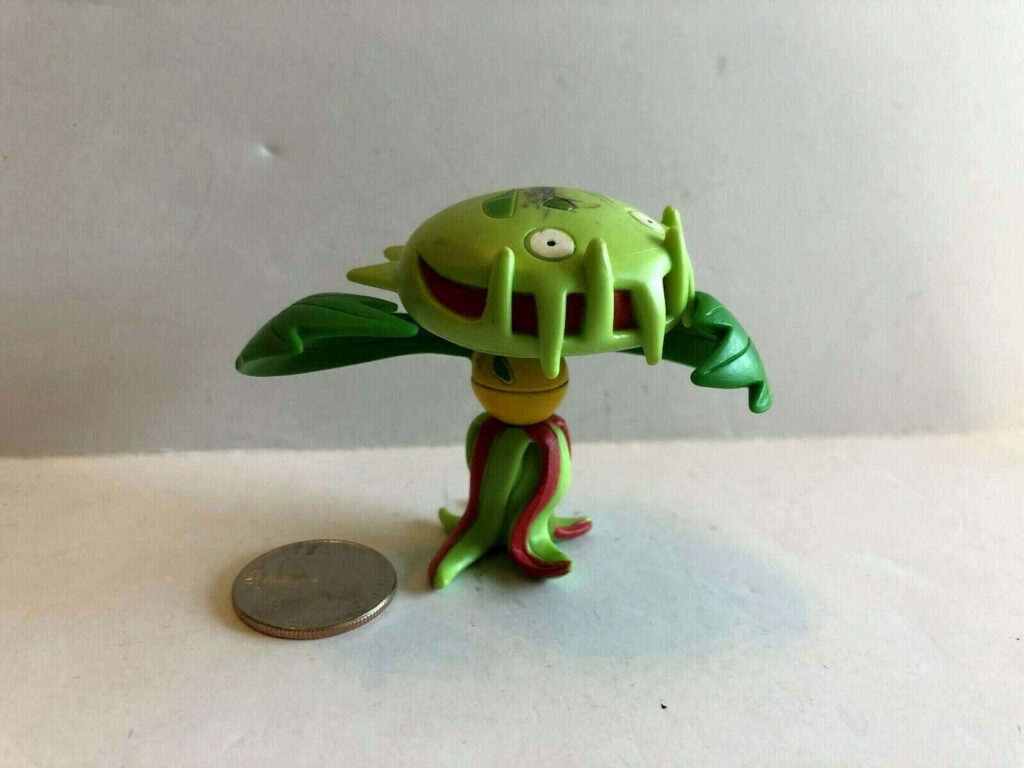 Detailed Carnivine Toy Model on Plain Background with Coin for Size Wallpaper
