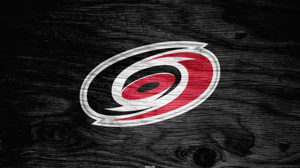 Carolina Hurricanes logo on textured dark wood background with bold red black white hues wallpaper