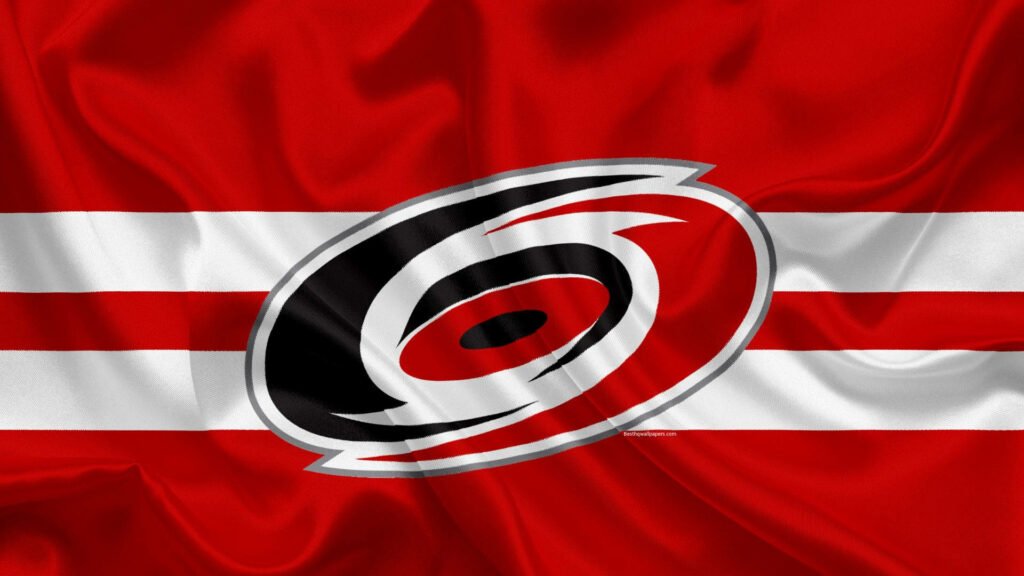 Carolina Hurricanes logo on bold red white wavy striped fabric background wallpaper