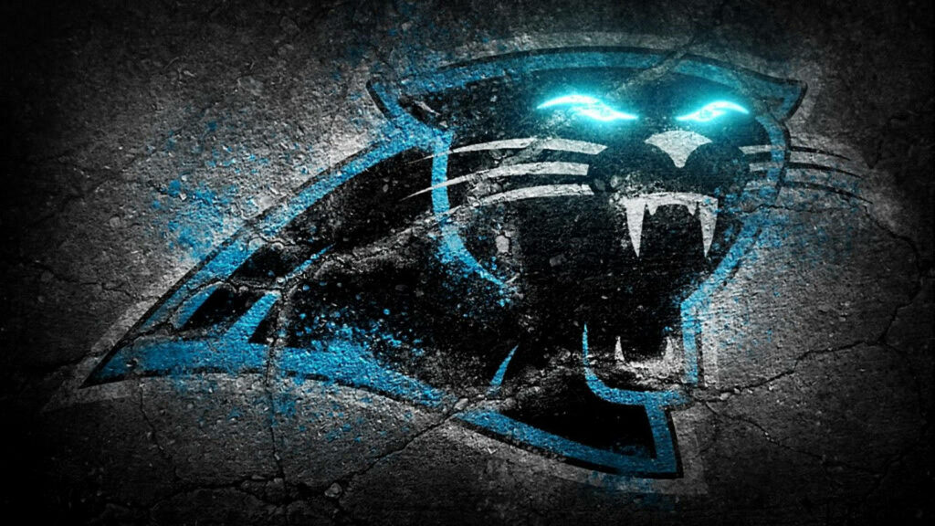 Carolina Panthers logo on dark rugged background with glowing blue eyes intense team spirit wallpaper