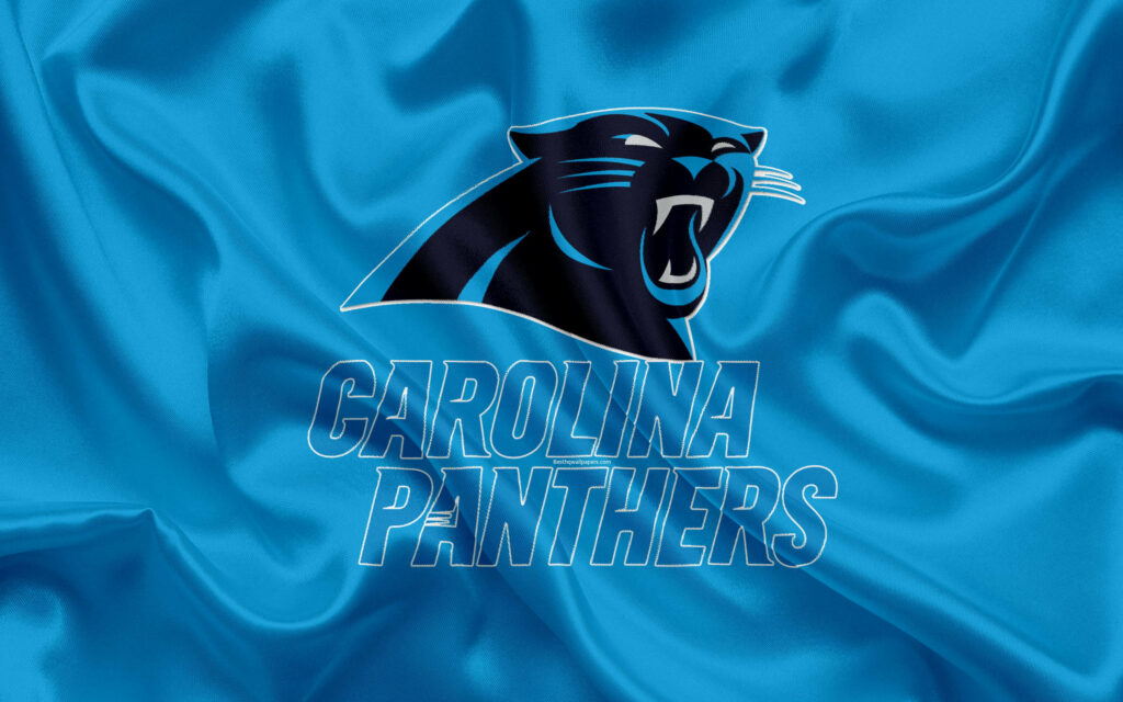 Carolina Panthers logo on vibrant blue satin fabric with sleek sharp black and blue panther icon Wallpaper