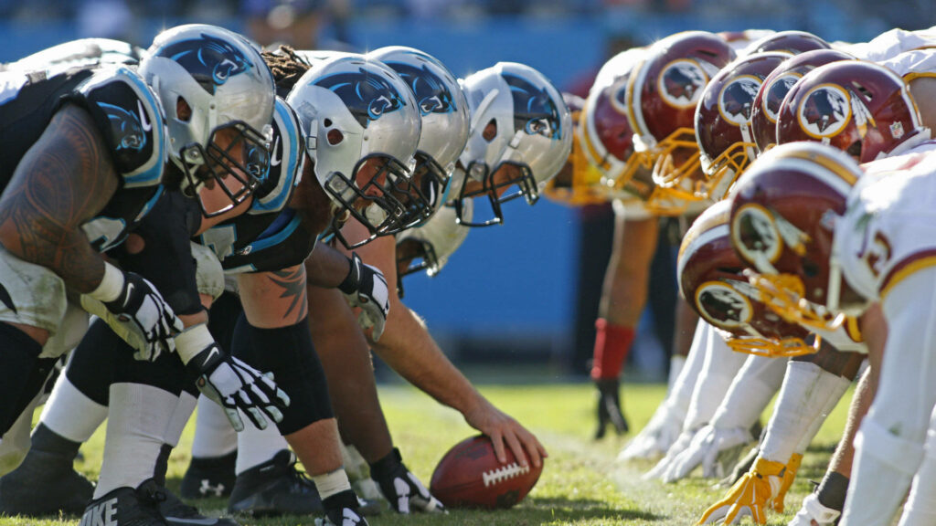 NFL game snap moment Carolina Panthers vs Washington Redskins vibrant uniforms intense energy Wallpaper