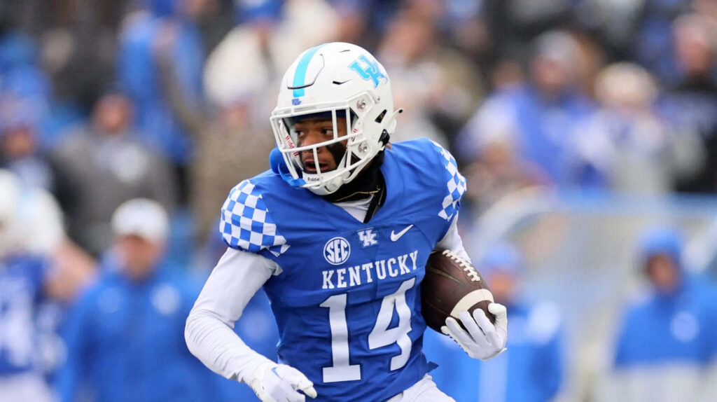 Carrington Valentine Kentucky Football number 14 blue white uniform gripping ball in motion wallpaper