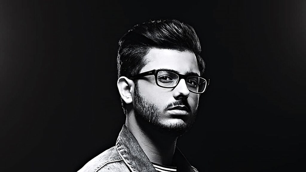 Black and white high contrast portrait of CarryMinati with stylish glasses on dark background wallpaper