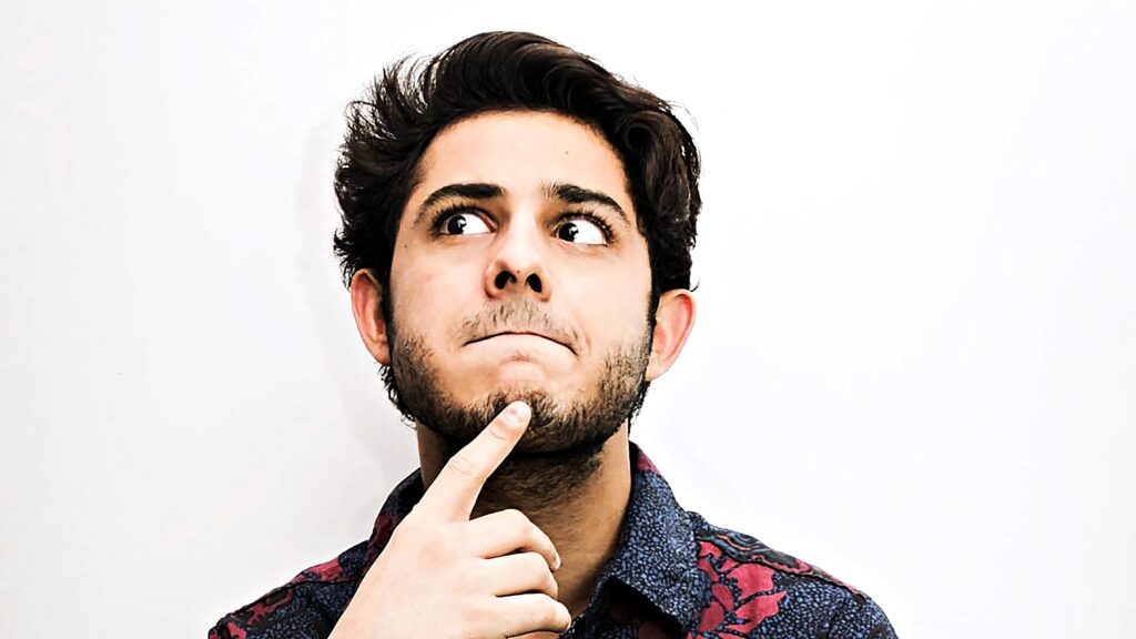 CarryMinati confused expression wallpaper thoughtful pose white background soft lighting