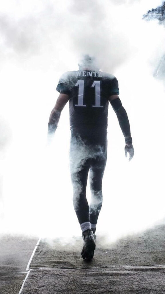 Carson Wentz football wallpaper number 11 walking through dramatic smoke with moody lighting
