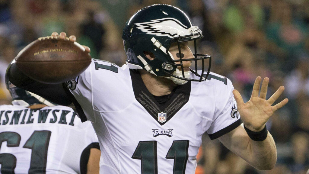 Carson Wentz Eagles No 11 quarterback mid throw vibrant team colors dynamic football action wallpaper