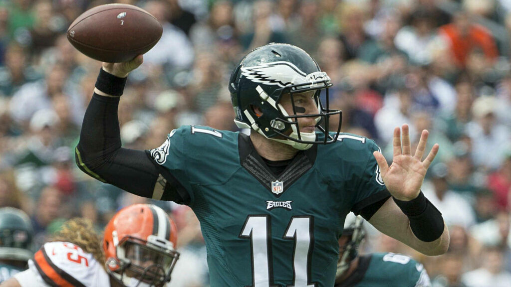 Carson Wentz Philadelphia Eagles green white uniform throwing pass NFL action stadium background Wallpaper