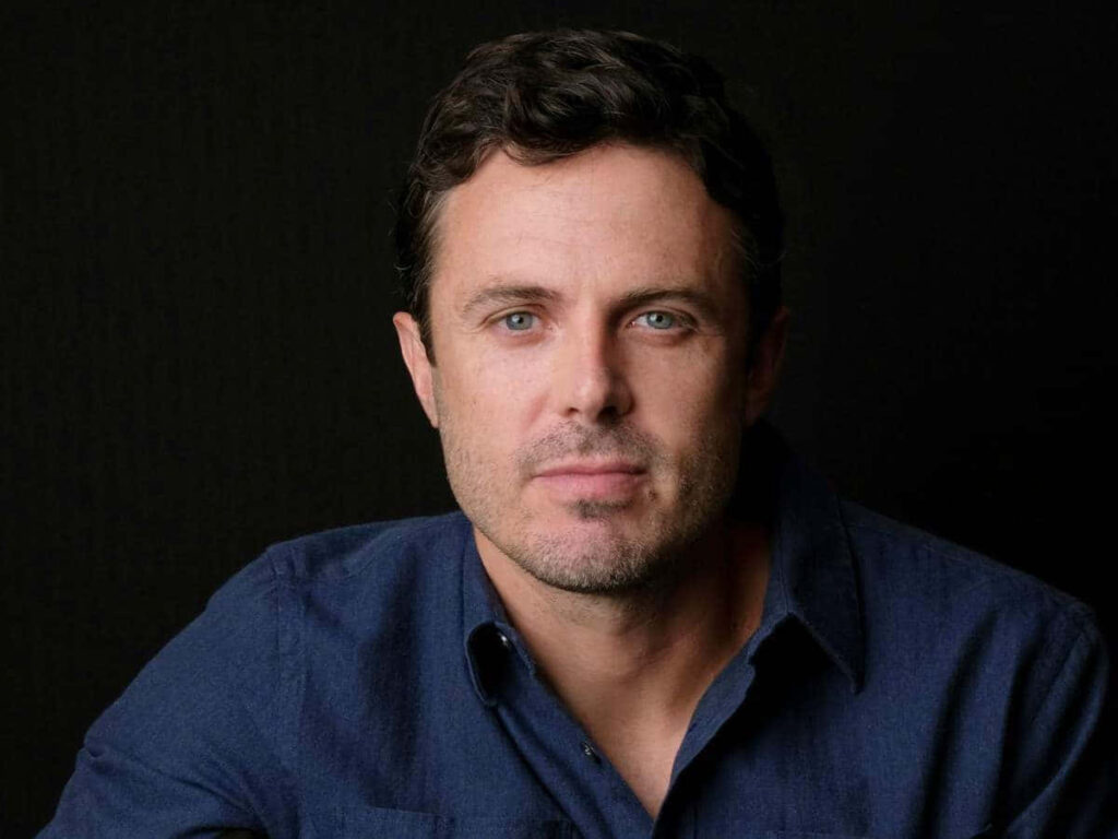 Casey Affleck portrait wallpaper with calm expression dark background soft natural lighting