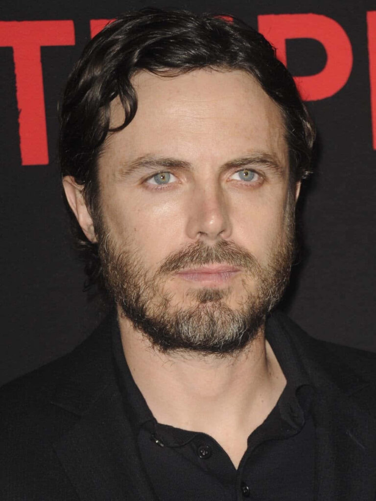 Casey Affleck close-up portrait dark background bold red lettering cinematic wallpaper