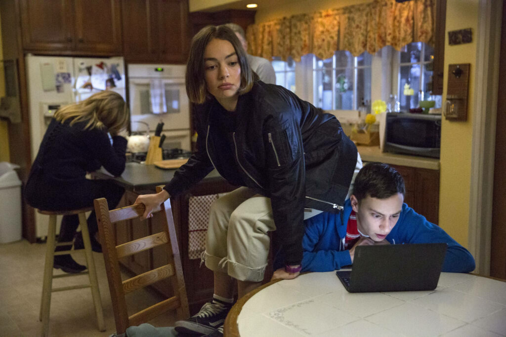 Casey and Sam from Atypical in cozy kitchen with laptop showing close sibling bond wallpaper
