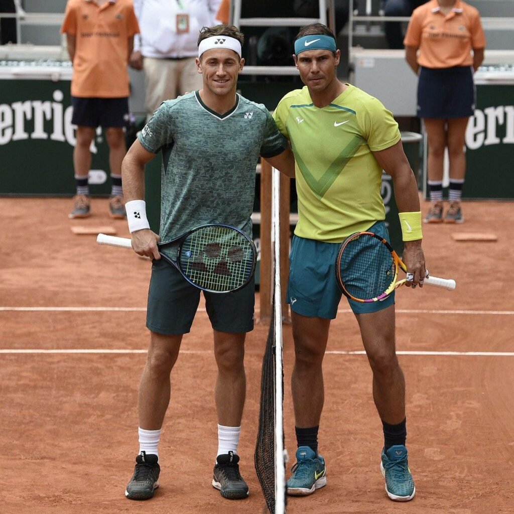 Casper Ruud and Rafael Nadal ready for clay court tennis match in vibrant sportswear wallpaper