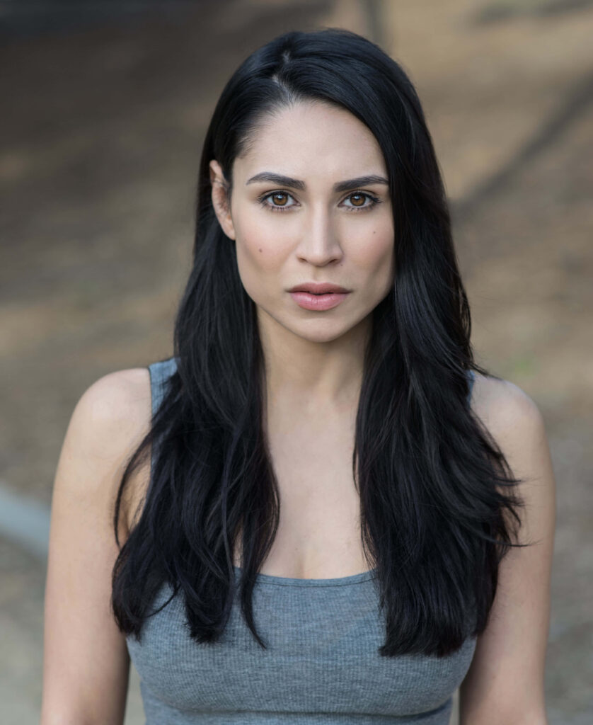 Cassie Steele portrait wallpaper with natural expression dark hair soft outdoor background neutral tones