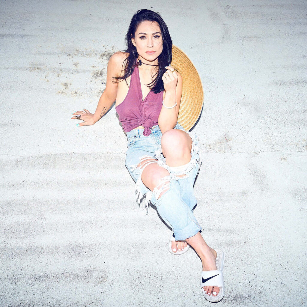 Cassie Steele in ripped light-wash jeans mauve knotted top white Nike slides urban street style Wallpaper