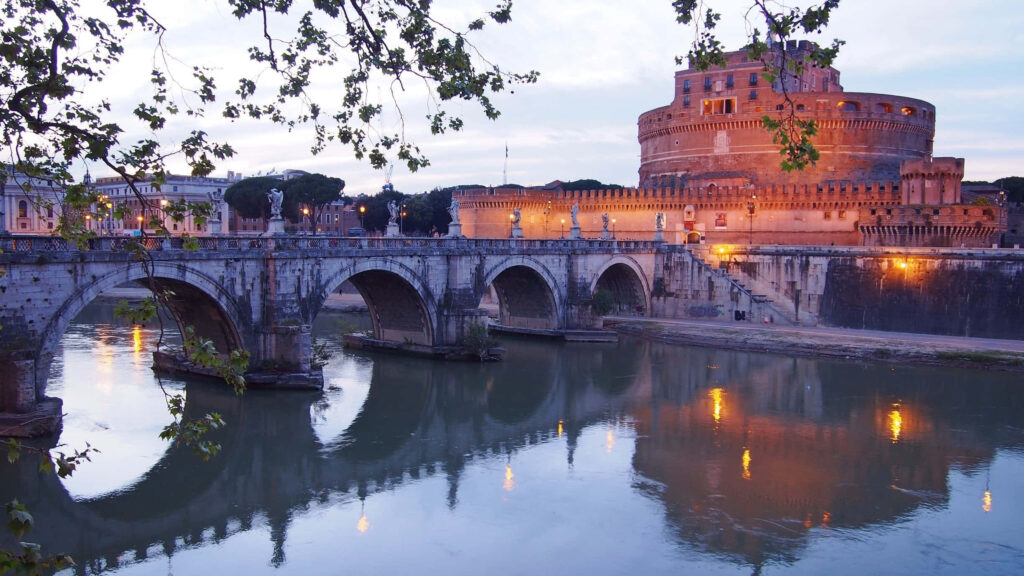 Castel Sant Angelo Bridge at dusk with golden lights reflecting on Tiber River in Rome Wallpaper