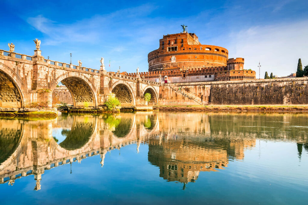 Marble bridge of Castel Sant Angelo in Rome reflected in calm river with historic statues Wallpaper